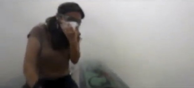 Still from amateur video uploaded to YouTube showing a young woman caught in a cloud of tear gas near Taksim Square, in Turquey