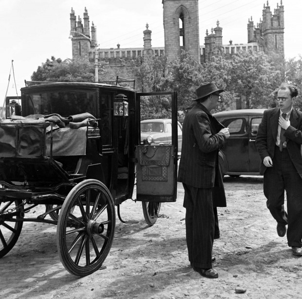 Poets Patrick Kavanagh and Anthony Cronin at the church in Monkstown with the carriage in which they’d been proceeding about Dublin in the footsteps of Leopold Bloom, the main protagonist in Ulysses - 50 years after Bloom traversed the city in James Joyce's novel. Image retrieved from the National Library of Ireland Commons.